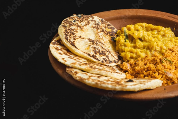 Fototapeta Sri Lankan style coconut roti bread with coconut sambol and dhal curry.