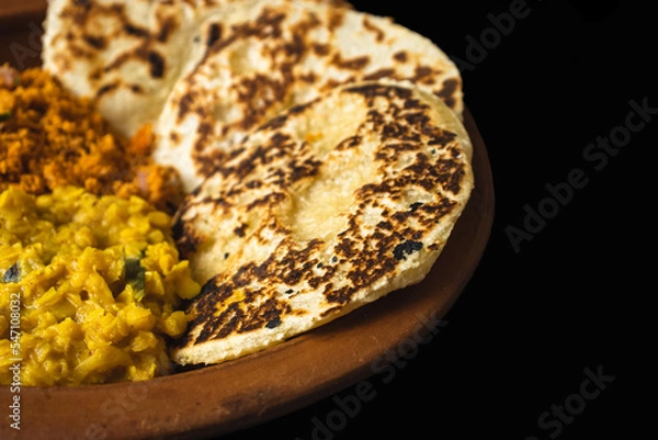 Fototapeta Sri Lankan style coconut roti bread with coconut sambol and dhal curry.