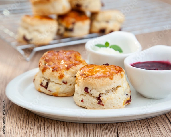 Fototapeta Cranberry scone set with raspberry jam and clotted cream