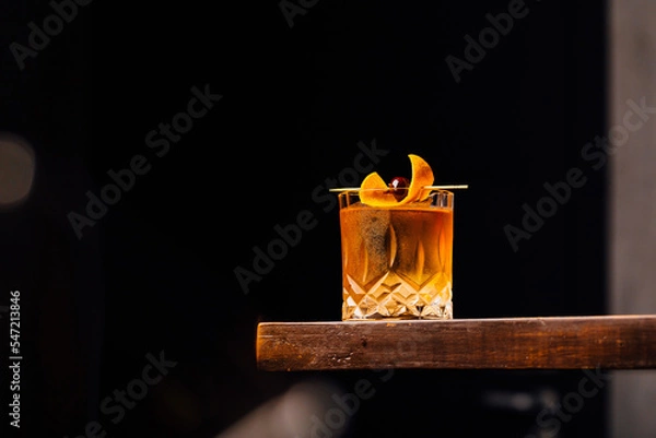 Obraz old fashioned cocktail classic bourbon whiskey and bitters, orange peel and cherry as garnish