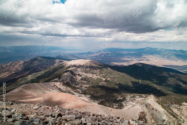 Fototapeta Rain clouds over Great Basin National Park as seen on a summer day from the summit of Wheeler Peak facing north. Stella Lake and Bald Mountain are seen in the distance. Located near Baker, Nevada.