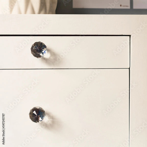 Obraz Front view of white drawers of a decorative furniture for you bedroom or living room