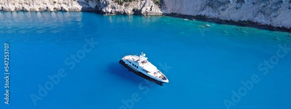 Fototapeta Aerial drone ultra wide panoramic photo of large luxury yacht anchored in paradise Mediterranean bay with turquoise crystal clear sea