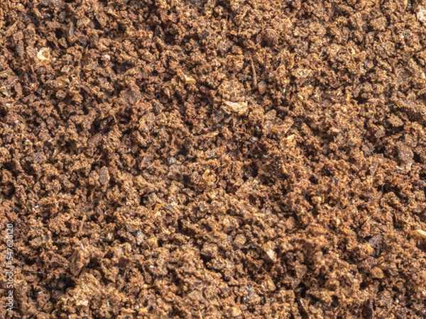 Fototapeta Ground coffee powder isolated on white background..Used coffee grounds after espresso machine and coffee beans on white  background.Caffeine addiction concept.