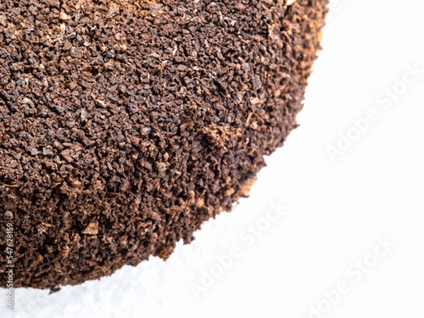 Fototapeta Ground coffee powder isolated on white background..Used coffee grounds after espresso machine and coffee beans on white  background.Caffeine addiction concept.