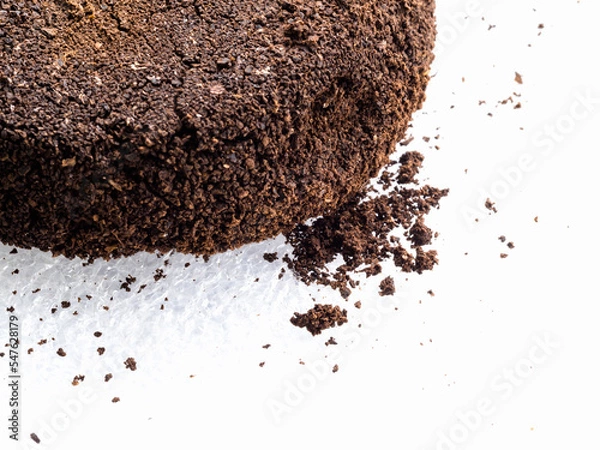 Fototapeta Ground coffee powder isolated on white background..Used coffee grounds after espresso machine and coffee beans on white  background.Caffeine addiction concept.