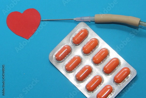 Obraz treatment of cardiac diseases, tablets in a blister on a blue background