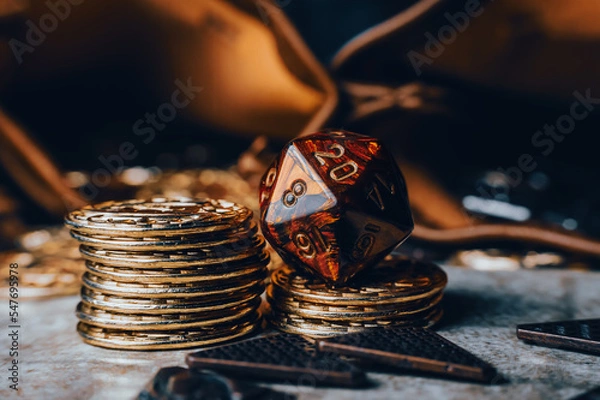Fototapeta Close-up image of a red RPG die on top of golden gaming coins