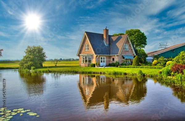Fototapeta Red bricks house in countryside near the lake with mirror reflec