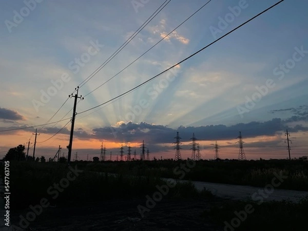 Fototapeta the sky in the clouds with the rays of the setting sun