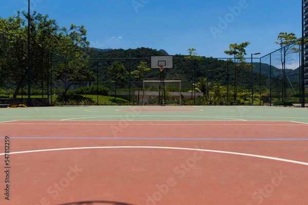 Fototapeta View of a sports court with beams and table with basket inside a park. Widely used for football, basketball and volleyball