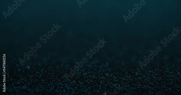 Fototapeta Bokeh glow background. Product placement. Underwater radiance. Defocused teal green blue color light shiny circles on dark abstract texture empty space poster.