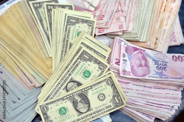 Fototapeta  Turkish Lira and American Dollars. Financial crisis, devaluation and exchange rates themed banknotes close-up