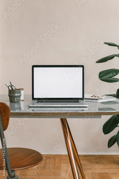 Fototapeta Office workplace. Blank laptop screen mockup on the table. Modern workplace. Minimal style. Copy space.