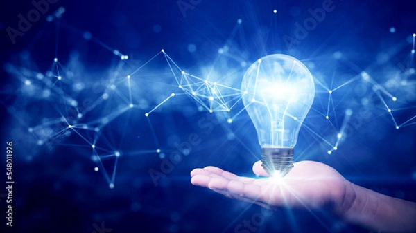 Fototapeta business idea creative concept technology. Illuminated light bulb and connected polygons above hand on dark blue background.