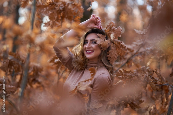 Fototapeta Size plus woman in a forest in the autumn