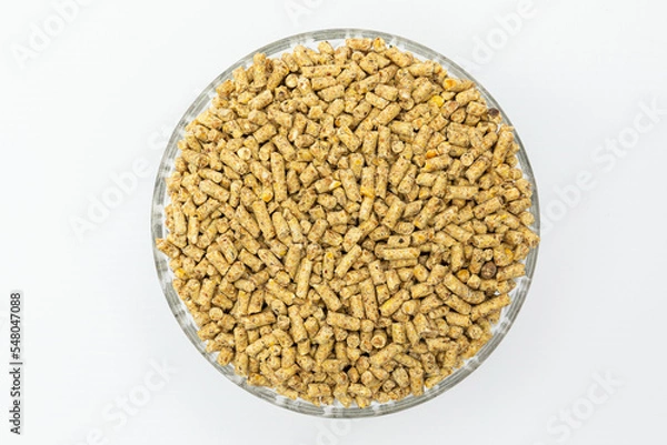 Fototapeta Fraction of feed additives for animals on a white background in a bowl