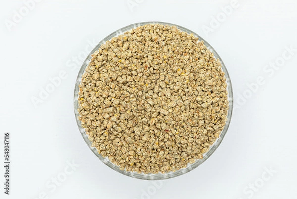 Fototapeta Fraction of feed additives for animals on a white background in a bowl