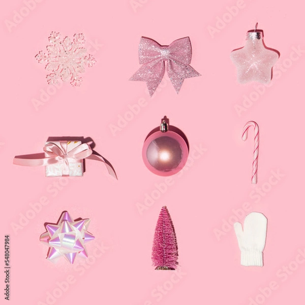 Fototapeta Christmas, New Year and winter symbols on pastel light pink background. Minimalistic holiday concept.