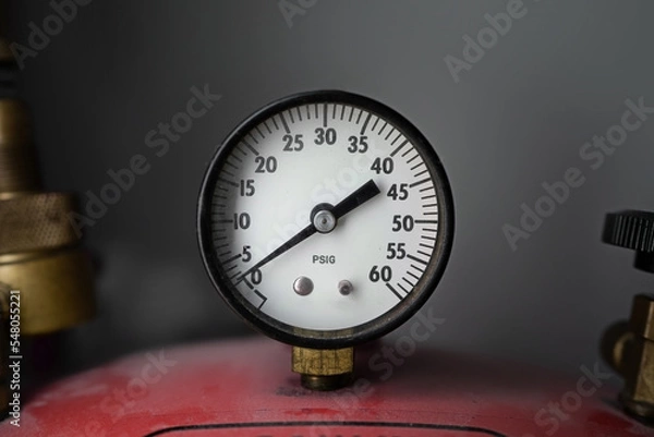 Fototapeta PSI Valve. pounds per square inch. red equipment with PSIG counter. pneumatic equipment that measures the pressure of a gas or liquid. Front view