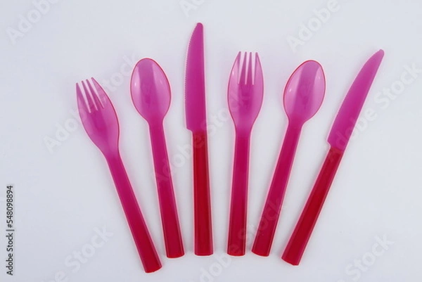 Fototapeta Pink plastic utensils: spoons, forks and knives
