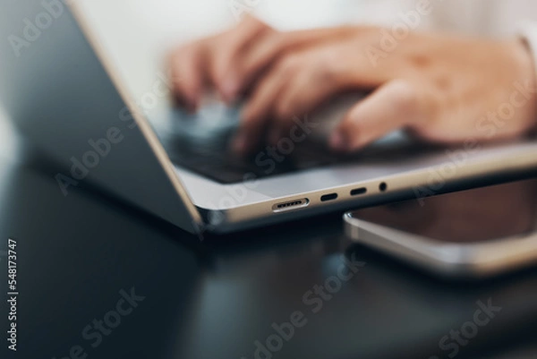Fototapeta closeup of hands typing on a notebook, keyboard