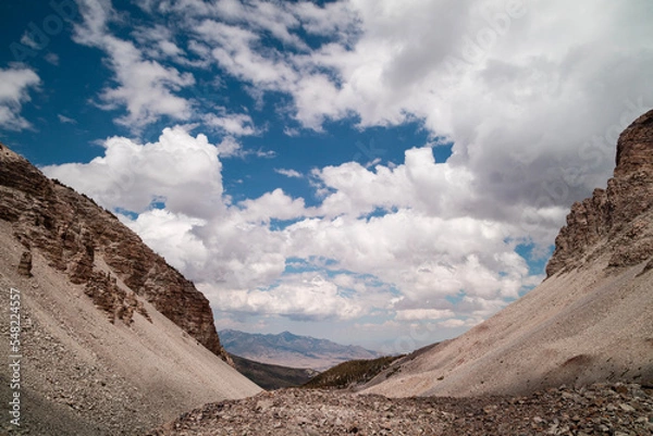 Fototapeta Clouds over Great Basin National Park on a summer day as seen from Wheeler Cirque looking northeast towards Mt. Moriah, which is seen in the distance. Located near Baker, Nevada..