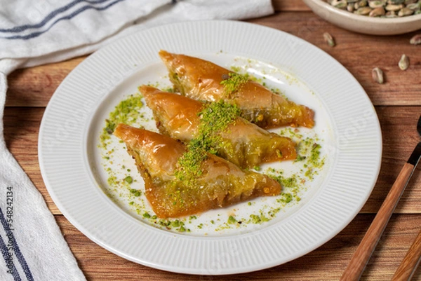 Fototapeta Sobiyet baklava with pistachio on wooden background. Turkish cuisine delicacies. Turkish baklava. close up