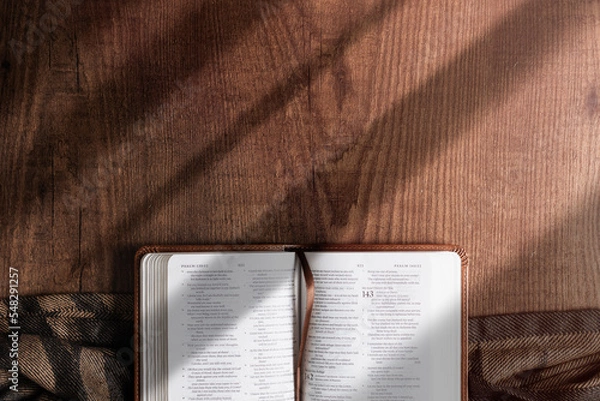 Fototapeta An open Bible on a wooden table, copyspace, flat lay bible