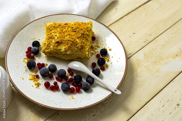 Fototapeta Napoleon cake with berries on a wooden table