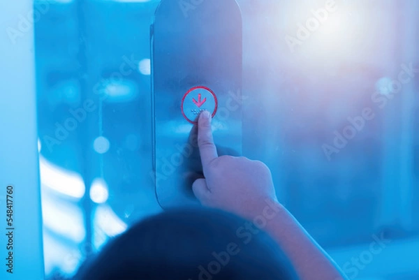 Fototapeta Hand pressing elevator button.