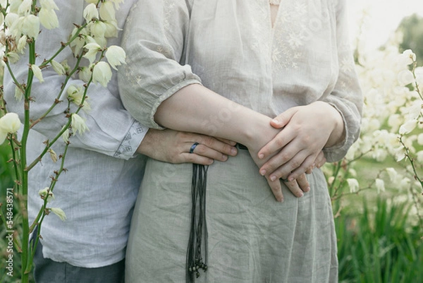 Obraz Close up lovers embrace concept photo. Summertime. Side view photography with blooming flowers in meadow on background. High quality picture for wallpaper, travel blog, magazine, article