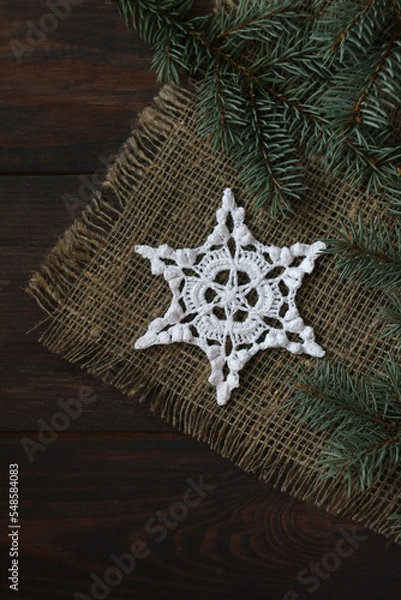 Obraz crochet white snowflake on linen backgraund