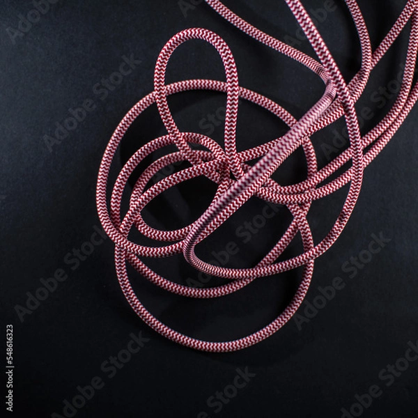 Obraz Red and White Braided Cable on Black Background