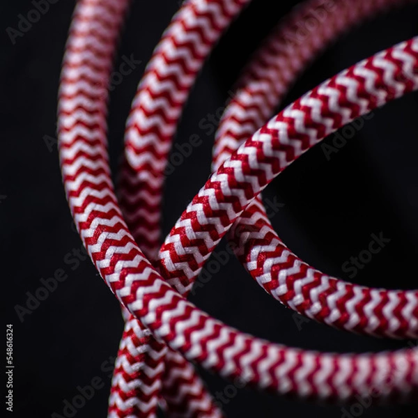 Obraz Red and White Braided Cable on Black Background