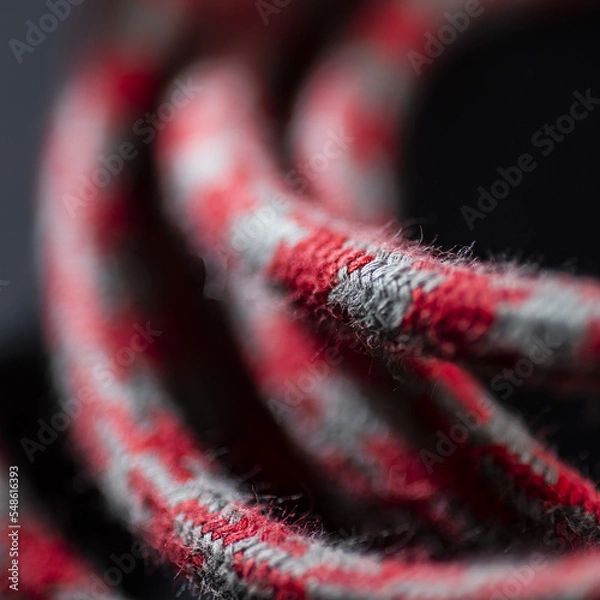 Obraz Red and Grey Braided Cable on Black Background