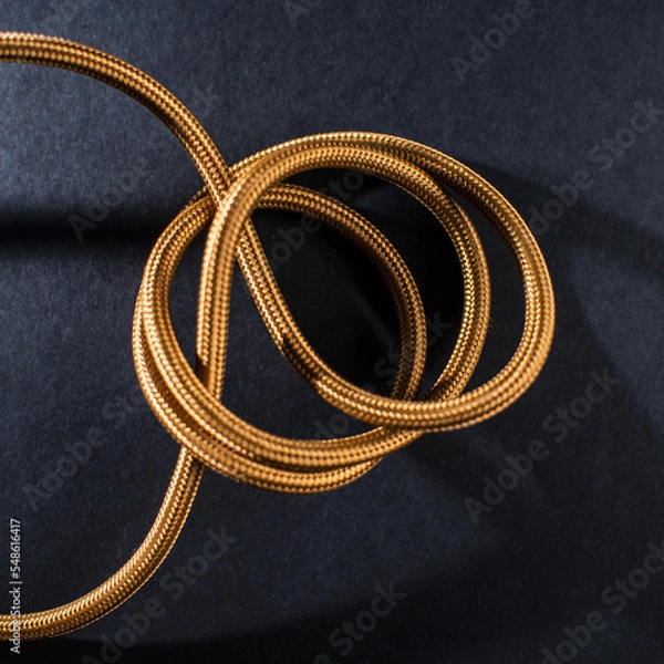 Obraz Gold Braided Cable on Black Background