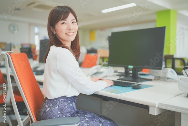 Fototapeta オフィスでデスクワークする女性