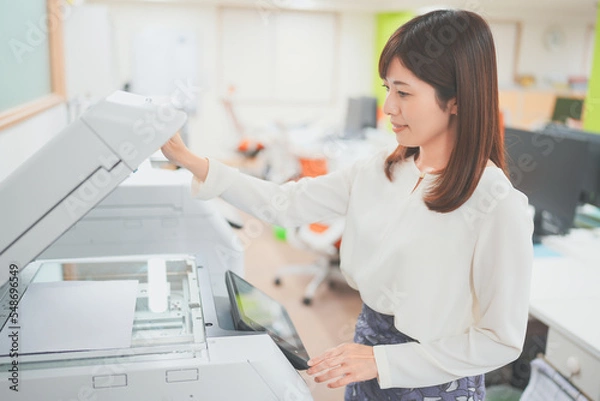 Obraz 職場でコピー機を操作する女性