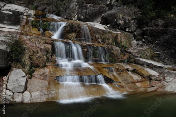 Fototapeta A view of the Cascata Fecha de Barjas waterfalls in the Peneda-Geres National Park in Portugal