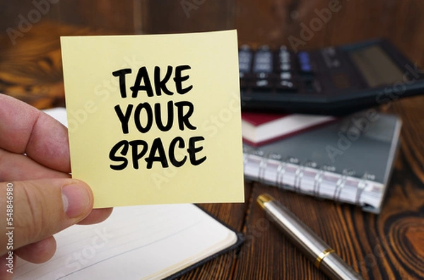 Obraz In the hands of a man is a sticker with the inscription - TAKE YOUR SPACE
