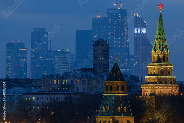 Fototapeta Moscow, Russia, evening view of the fortress towers of the Kremlin and the skyscrapers of Moscow City.