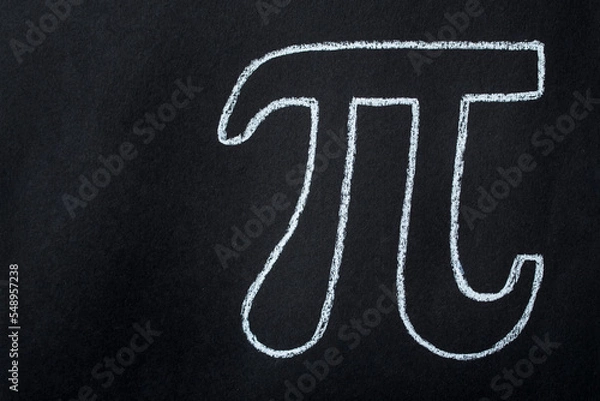 Fototapeta The Greek letter Pi is drawn in chalk on a black board in honor of the international number Pi for March 14