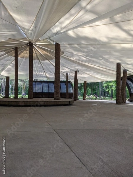 Fototapeta scene in an open-air park with an awning from rain and sun
