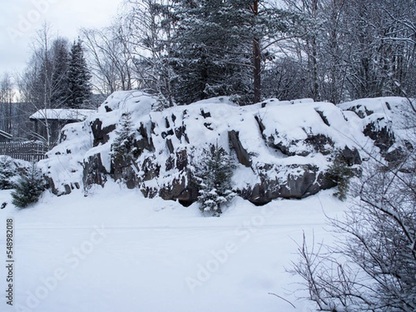 Fototapeta Snow-covered rocks and trees in Norway