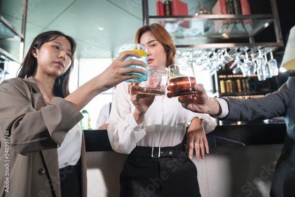 Fototapeta Business team cheers with front bar at hotel restaurant