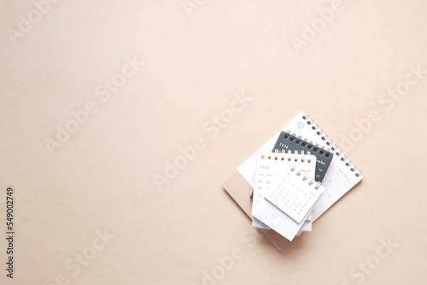 Fototapeta deadline concept with stack of calendar and pencil on color background 