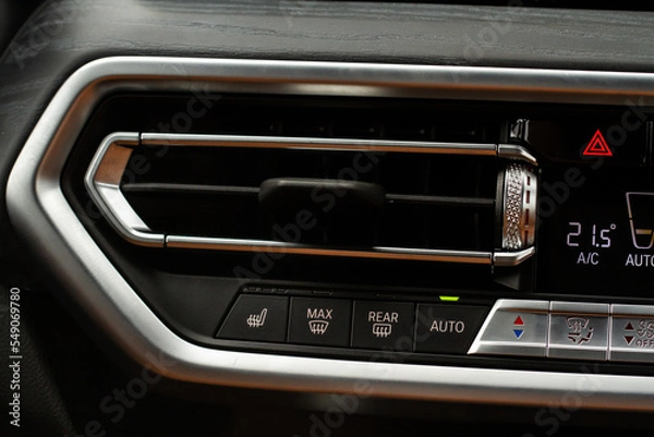 Obraz Windshield defrost button. Modern car interior details. Windshield heating close up view.