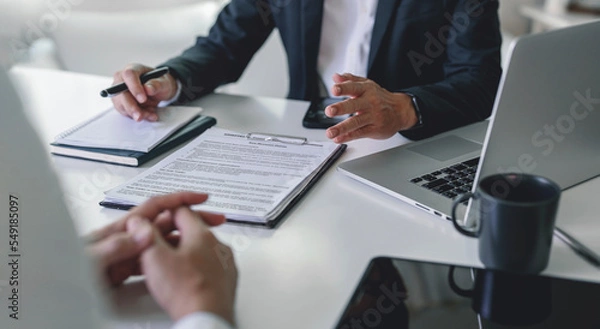 Fototapeta Two businessman meeting and consulting business information, sitting in modern office and working on laptop.