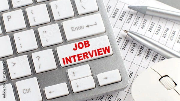 Fototapeta JOB INTERVIEW text on a keyboard wirh chart and pencil